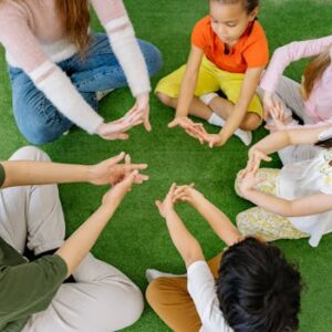 A group of diverse children sit in a circle, engaging in play and learning activities.
